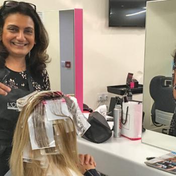 Alan d hairdressing teacher Sejal putting highlights in a womans hair.