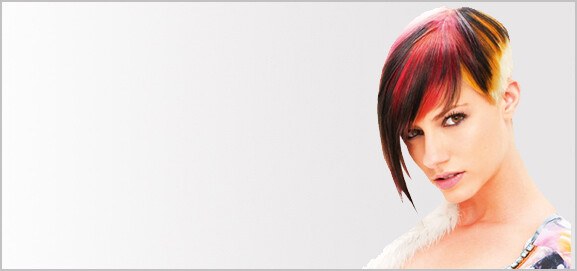 Female hair model with short dark brown hair and red and orange highlights.