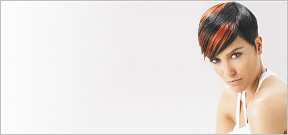 Female hair model with short dark brown hair and orange highlights.